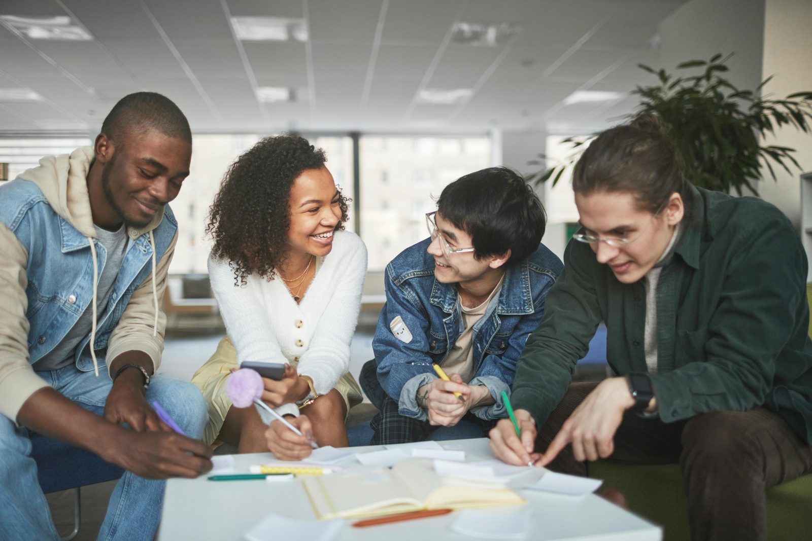 Young adults studying and planning together around a table